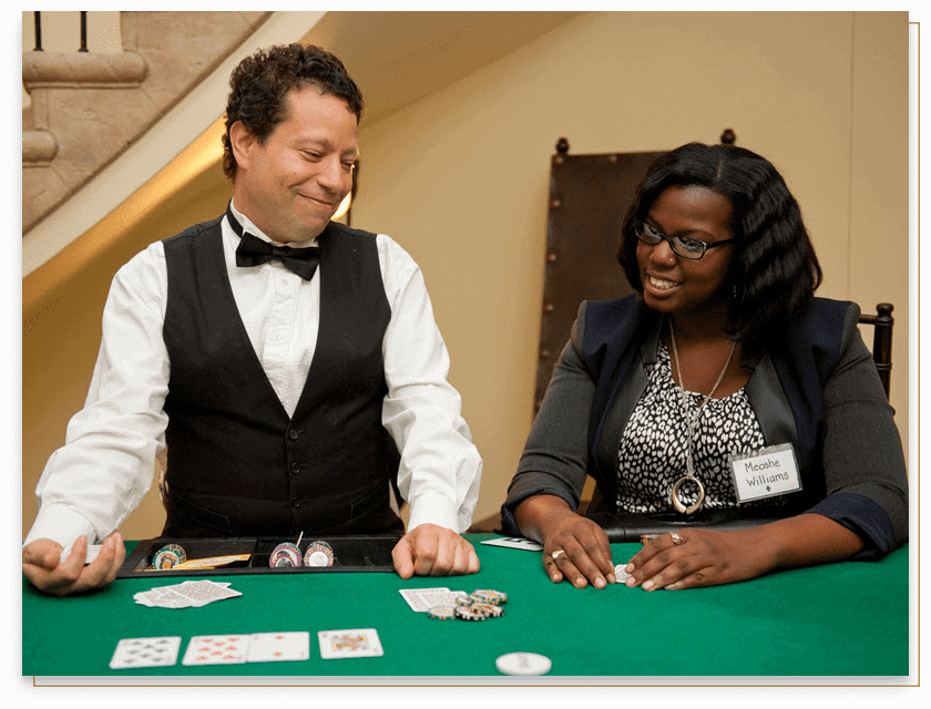 poker dealer in a tux smiling at a player on his left
