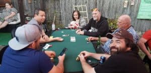 A table full of happy people playing poker.