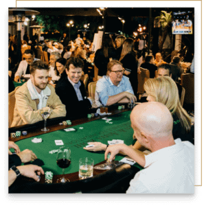 A group of people at a poker table focused on playing.