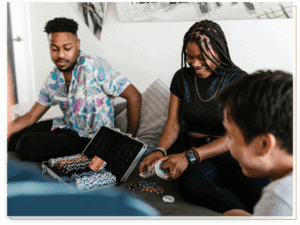 Man and woman playing poker on a bed.