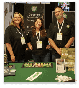 Owners Lara, Pamela, and Scott standing behind a poker table.