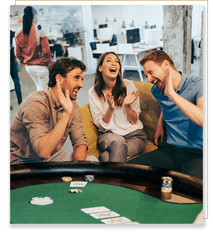 People in an office laughing and having fun while playing poker.
