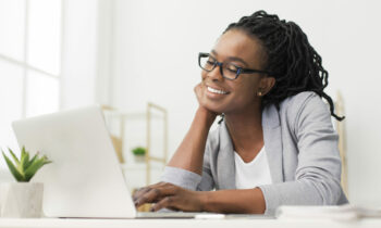 African American woman looking at her laptop.